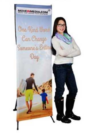 Woman standing next to banner